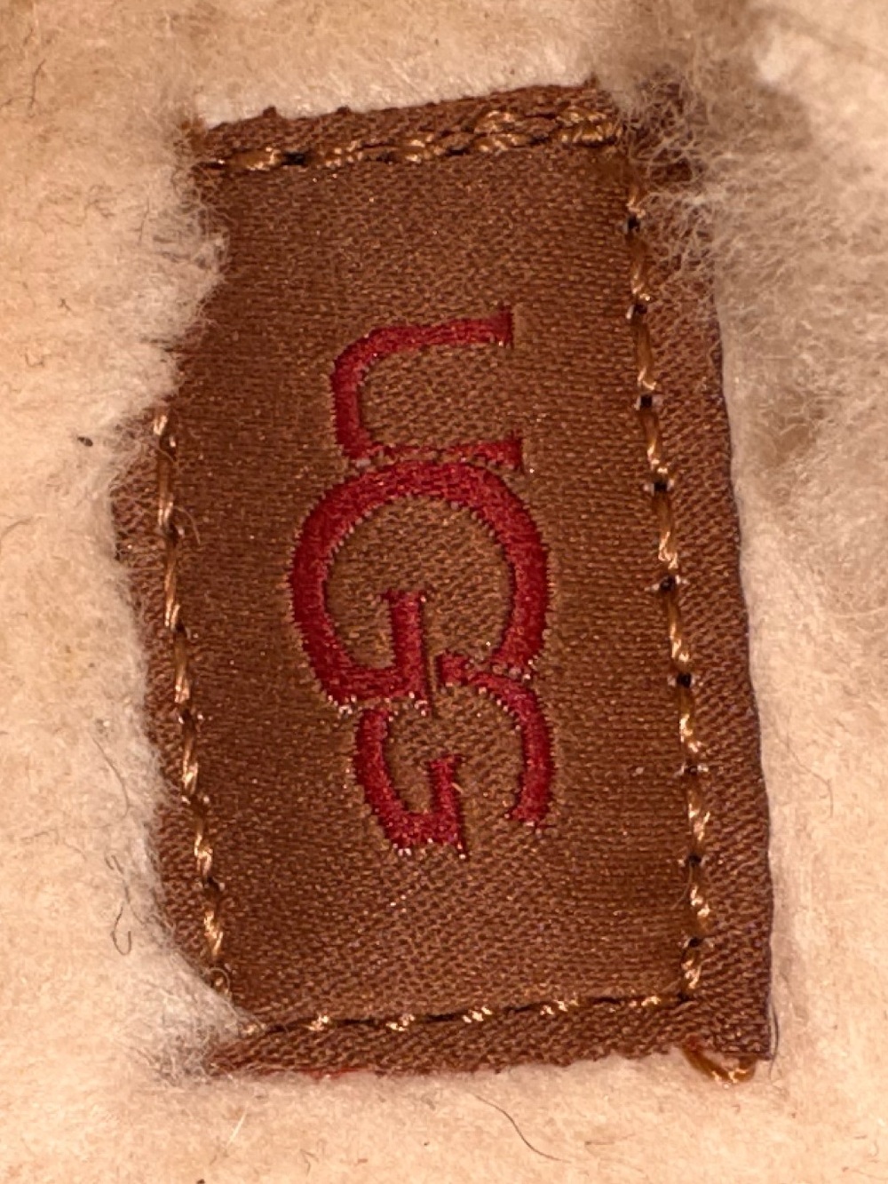 UGG Cream Sherpa Slip-On with Brown Label and Red Logo